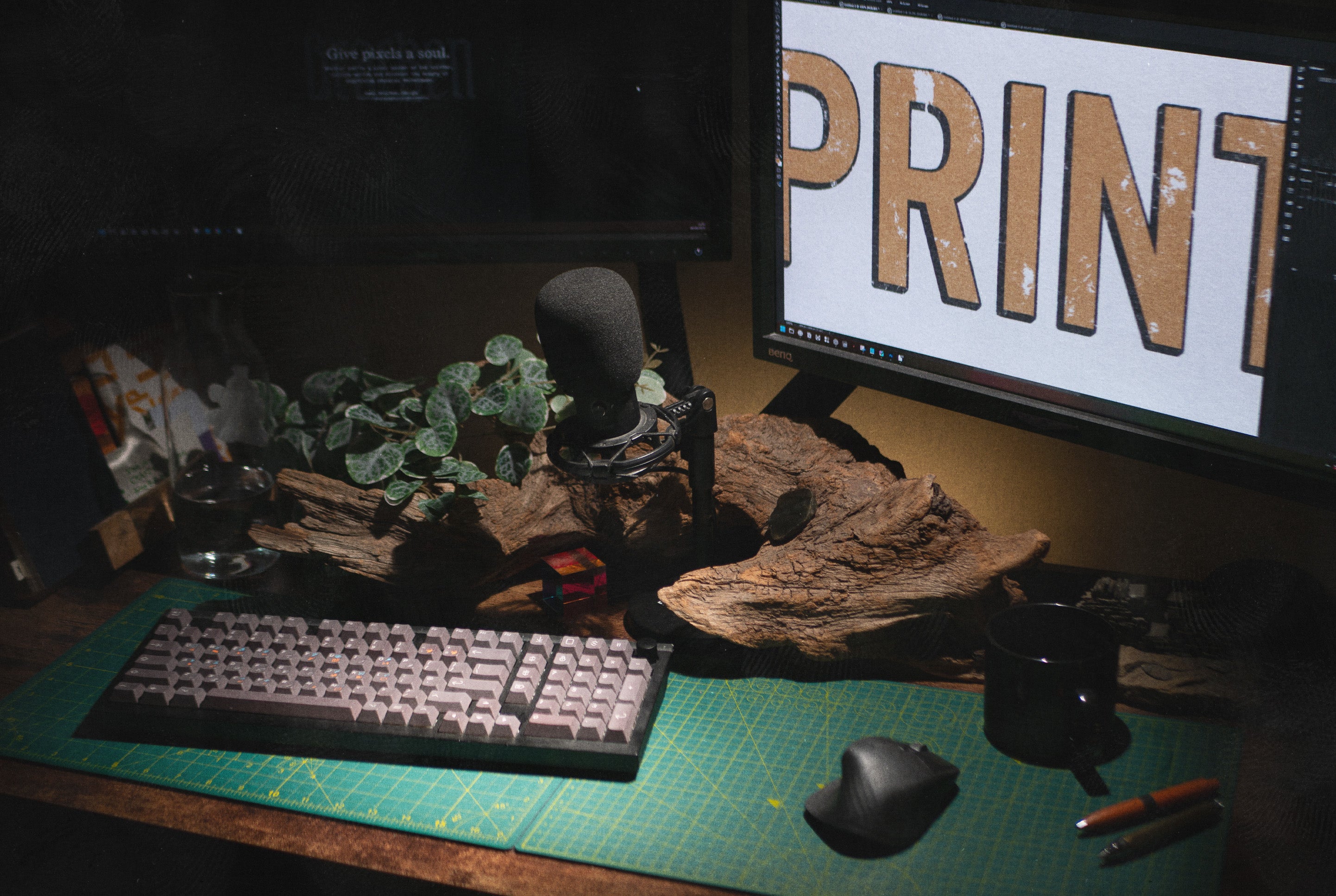 Desk setup with keyboard, mouse, and monitor displaying the word 'PRINT'.